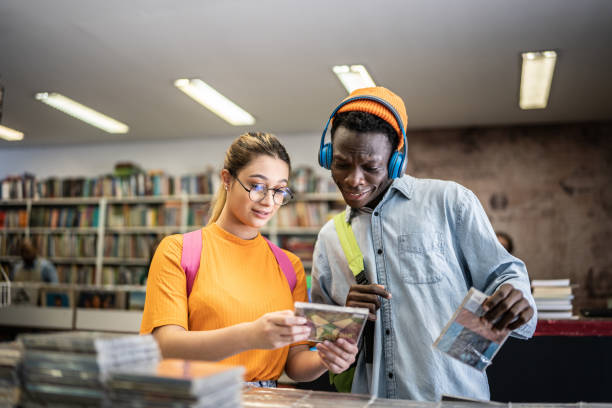 istock Friends browsing in a music store 1356940613