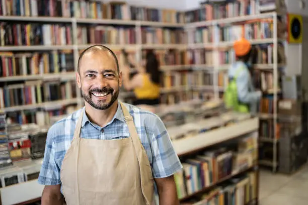 Portrait of a happy bookstore owner