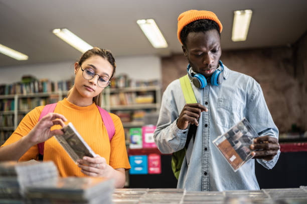 istock Friends browsing in a music store 1356940635