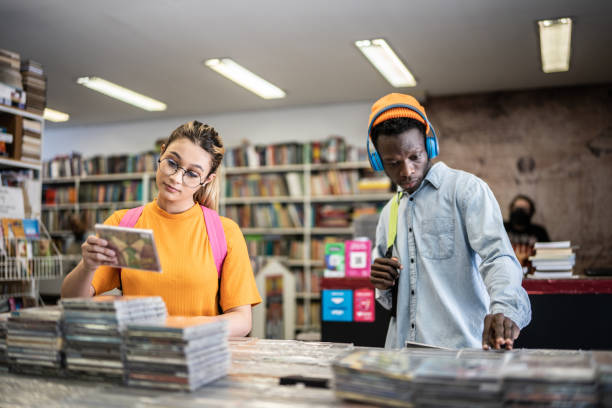 istock Friends browsing in a music store 1356940642