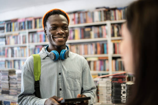 istock Happy young man buying something in a thrift store 1356940681