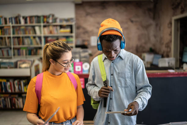 istock Friends browsing in a music store 1356940686