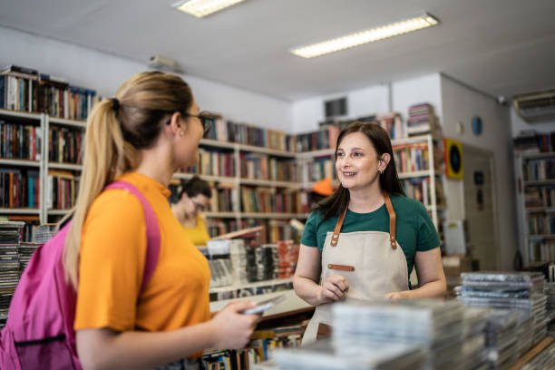 Saleswoman helping customer in a thrift store