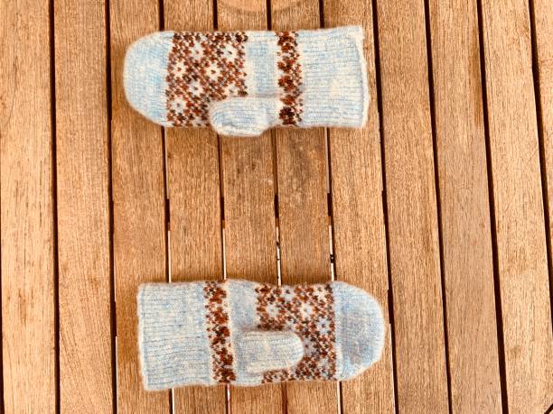 istock A pair of mittens on wooden background . Copy space 1356940881