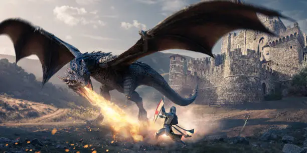 A large dragon with outstretched wings with open mouth, breathing a jet of fire towards the ground close to a  knight wearing a suit of armour and holding up a shield for protection. The conflict occurs on stone and grassy ground next to a stone castle at dawn/dusk.
