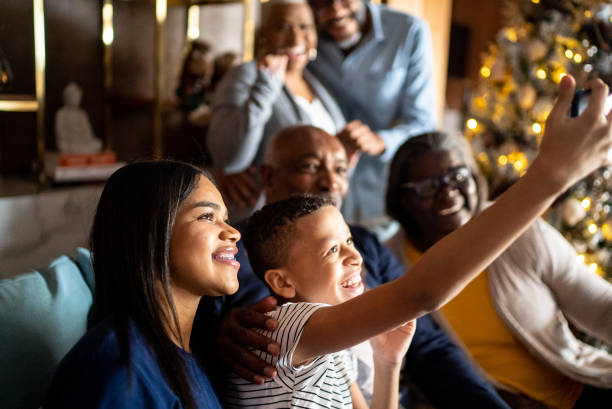 istock Multi generation family taking a selfie or doing a video call during Christmas at home 1356945083