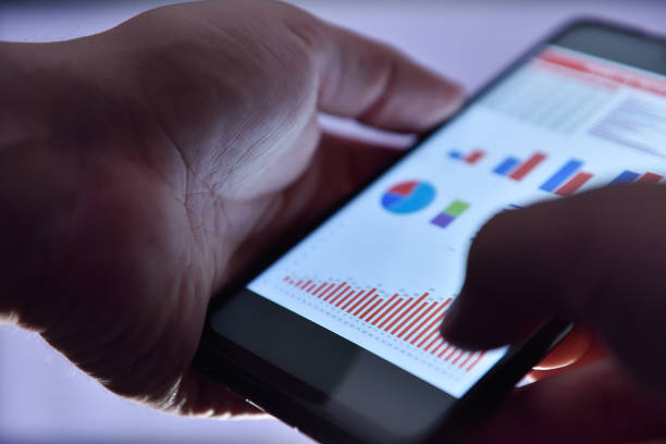 istock Close up of businessman hands using smart phone 1356947898