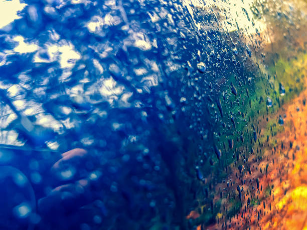 A blue lacquered metal covered with raindrops.