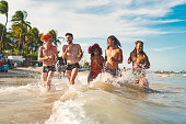 People running on the tropical beach