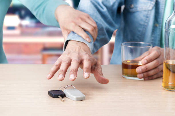 Don't drive drunk Do not drink and drive! Cropped image of drunk man talking car keys and his friend stopping him liquor store counter photos stock pictures, royalty-free photos & images