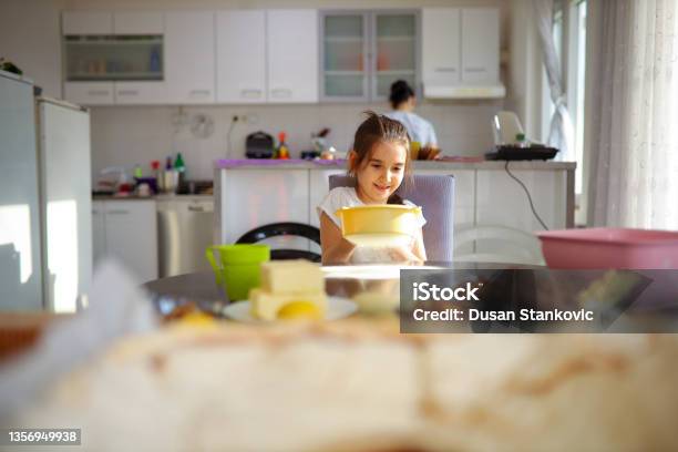 Happy Girl Sift The Flour Onto Dining Table Int He Kitchen Stock Photo - Download Image Now