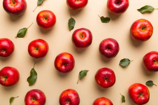 istock Many red apples on colored background, top view. Autumn pattern with fresh apple above view 1356950128