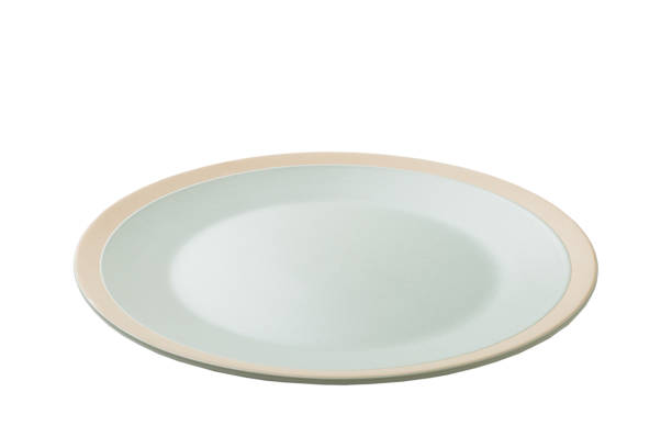 istock Blue ceramic round plate isolated over white background. perspective view 1356950232