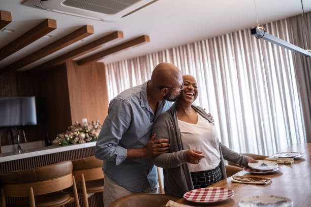 mature couple setting the table for lunch or dinner at home - lifestyles residential structure community house imagens e fotografias de stock