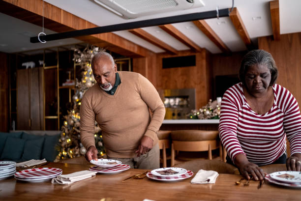 istock Senior couple setting the table for Christmas dinner or lunch at home 1356952749