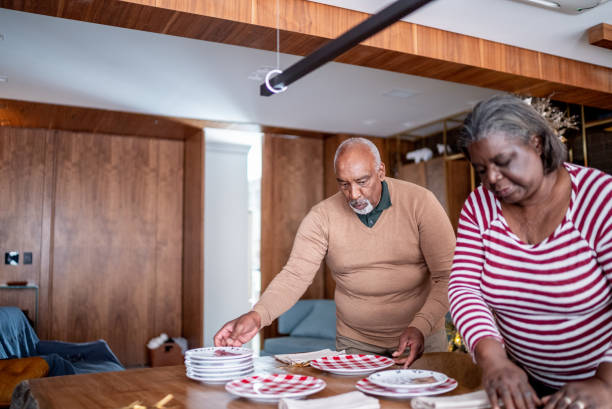istock Senior couple setting the table for dinner or lunch at home 1356952764