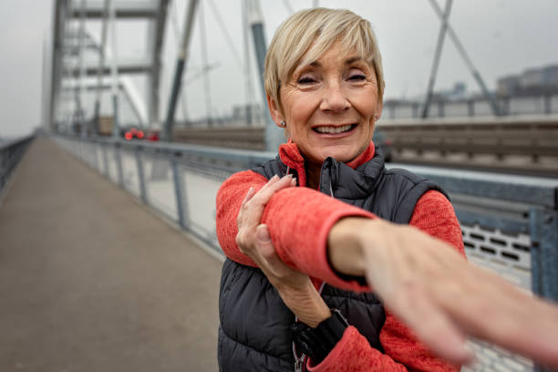 istock Active senior woman stretches her muscles before running. 1356952998