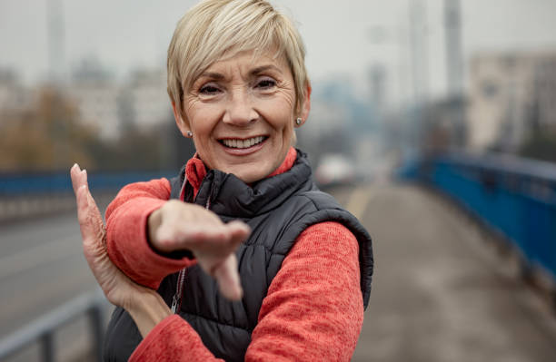 istock Active senior woman stretches her muscles before running. 1356954457