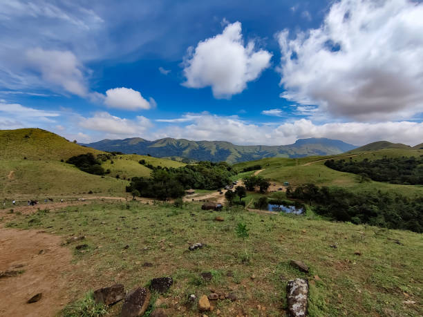istock Mesmerizing cloudy blue sky over the green valley and distant hills from Mandalpatti Hill station 1356954535