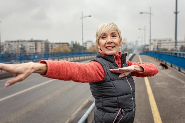 istock Active senior woman stretches her muscles before running. 1356957251
