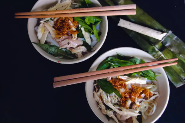 Banh Uot Long Ga, unique vietnamese dry rice noodles (flat and wide like wet rice cake noodle) dish mixed with herbs and meat, a local delicacy of Da lat Vietnam