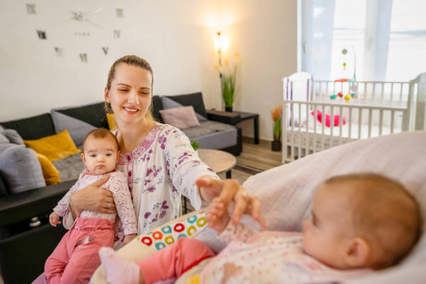 istock Mother spending time with her newborn babies 1356963253