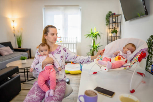 istock Mother spending time with her newborn babies 1356963259