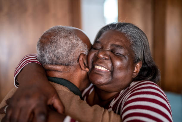 istock Senior couple hugging each other at home 1356964158