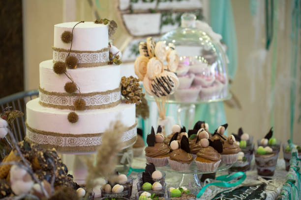 istock Wedding cake with cupcakes at the exhibition 1356964541