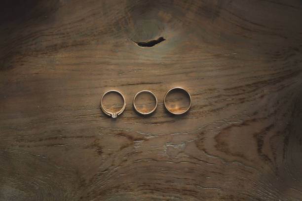 istock wedding ring on wooden background 1356964763