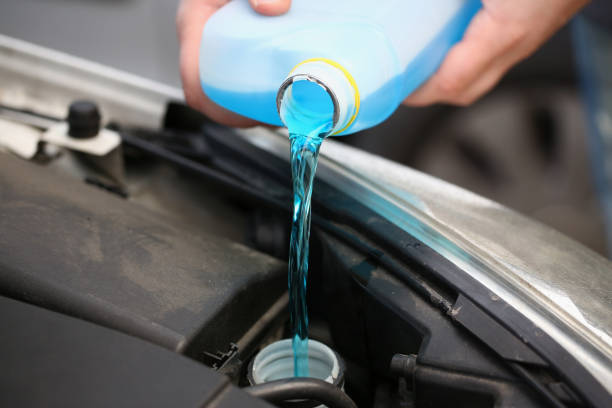 istock A man pours antifreeze from a canister into a car engine 1356965601