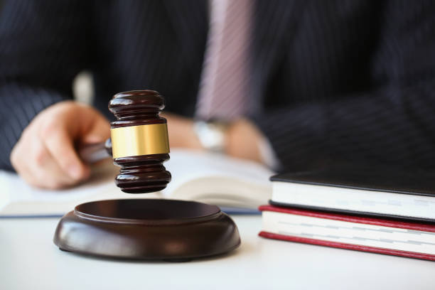 istock A man in a judge's gavel in his hands, close-up 1356965604