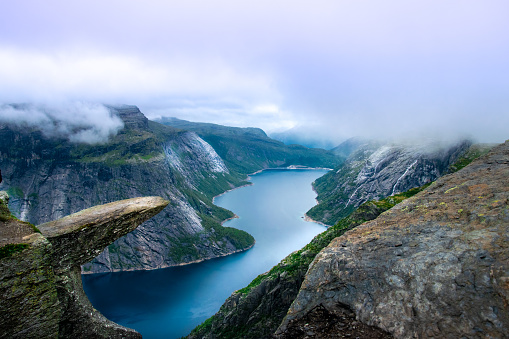 Famous place in Norway - Trolltunga. In the background, majestic fjords and lakes