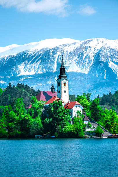 beautiful and spectacular julian alps and lake bled. an island on a lake and snow-capped mountain peaks in the background. amazing church on the island. slovenia - julian alps mountain lake reflection imagens e fotografias de stock