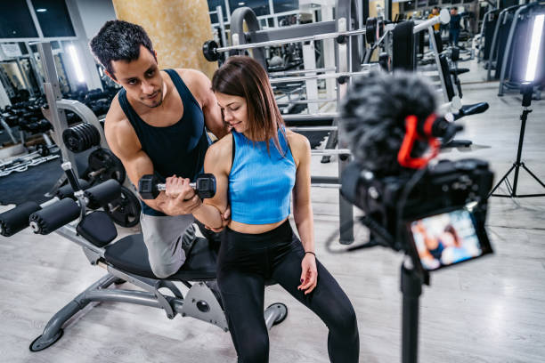 istock Two People Filming A Workout At The Gym 1356965921