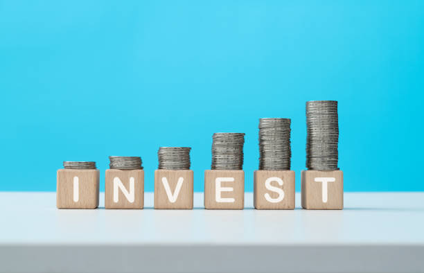 istock Stack of coins on word invest 1356965960
