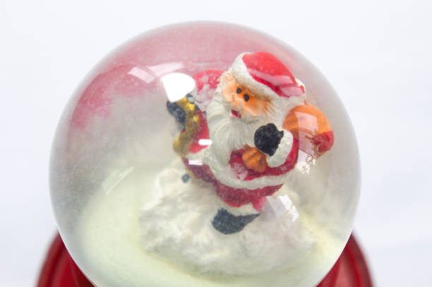 istock Santa Claus inside a glass globe 1356965986