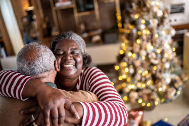 istock Senior couple hugging each other at home 1356966450