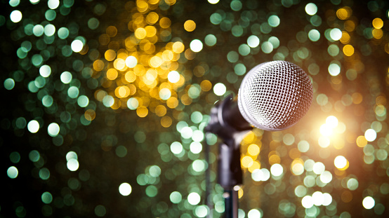 Microphone on shiny colorful background.