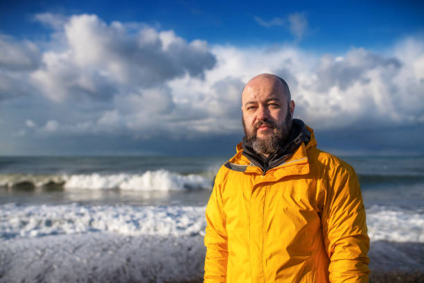 istock Mature man at the sea coast 1356967124