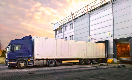 Trucks at the warehouse loading bays at the sunset