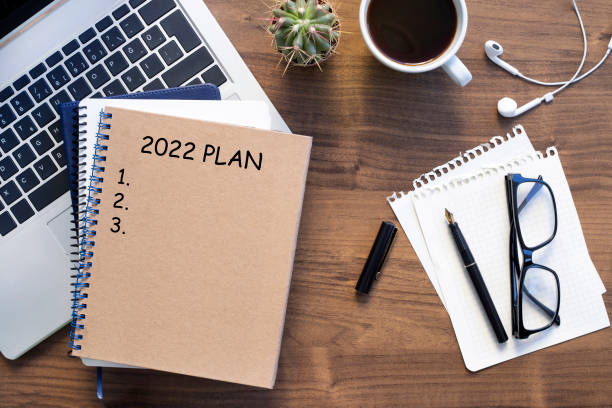 istock Note book with 2022 goals text on it to apply new year resolutions and plan. 1356968790