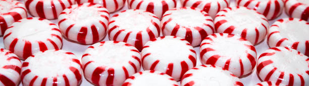 istock banner size christmas peppermint hard candy cane mints close up background 1356970355