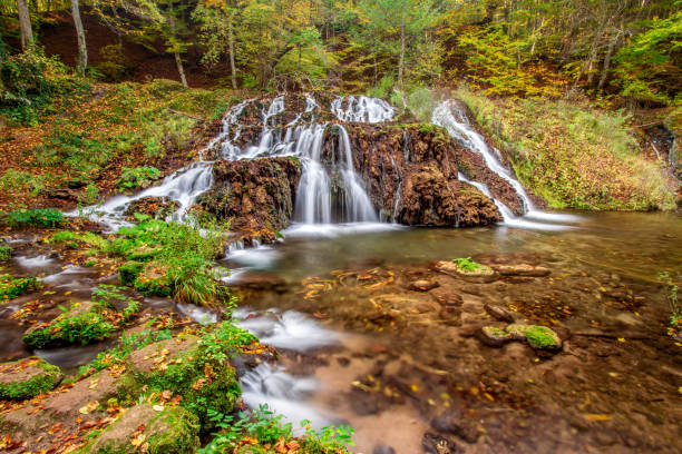 istock Autumn mountain waterfall stream landscape 1356971878