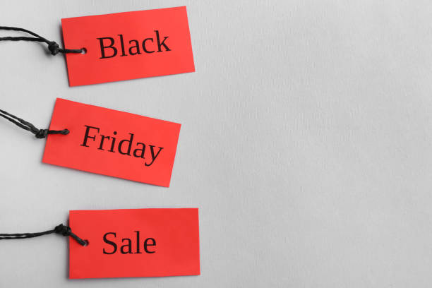 istock Red tags with words BLACK FRIDAY SALE on light background, top view 1356972369