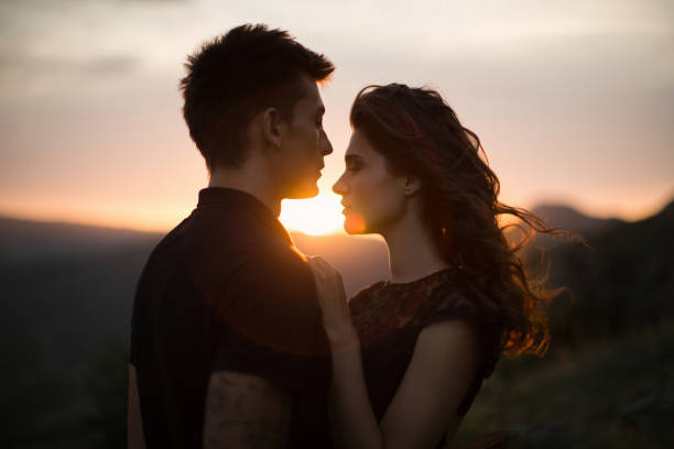 istock Silhouette sweethearts at sunset 1356974727