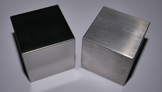 A tungsten (left) and a magnesium cube. Though they have the sime size, the tungsten cube is 10x heavier!