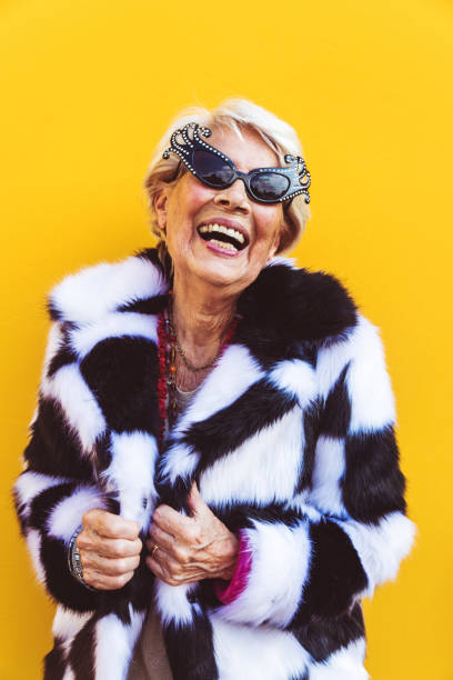 Senior woman with fancy style Happy and playful senior woman having fun - Portrait of a beautiful lady above 70 years old with stylish clothes, concepts about senior people bizarre fashion stock pictures, royalty-free photos & images