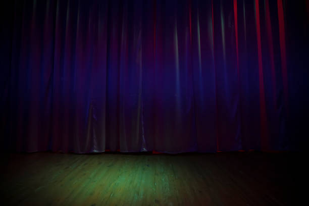 istock Green dark stage floor and dark purple curtains. 1356977514
