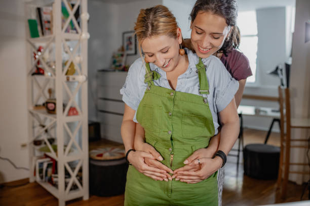 Happy lesbian couple waiting for baby stock photo